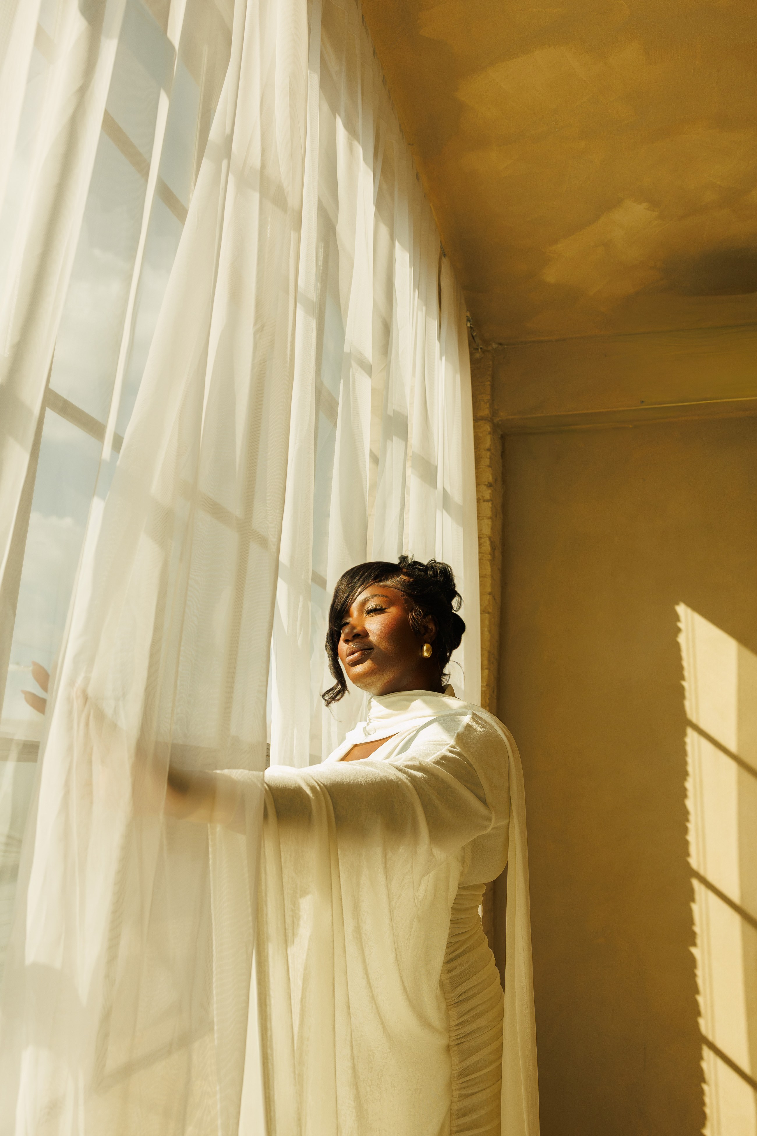 Jowoda posing in a terracotta studio portrait